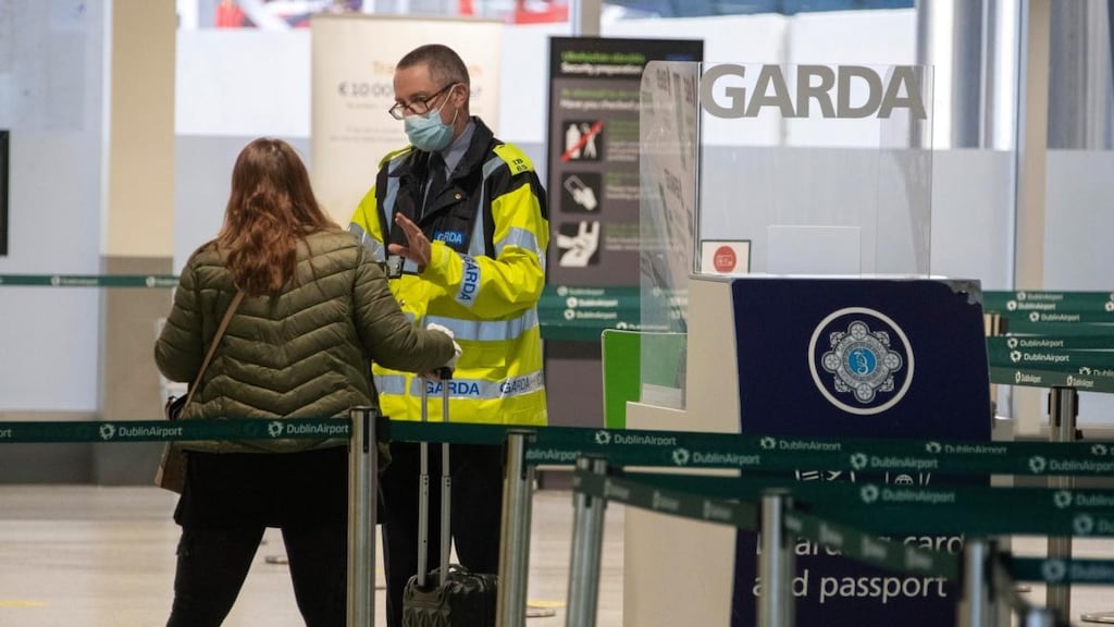 A Garda speaks with a passenger at a checkpoint at the departure gates in Terminal 1 at Dublin Airport on Monday. Photograph: Colin Keegan/Collins
