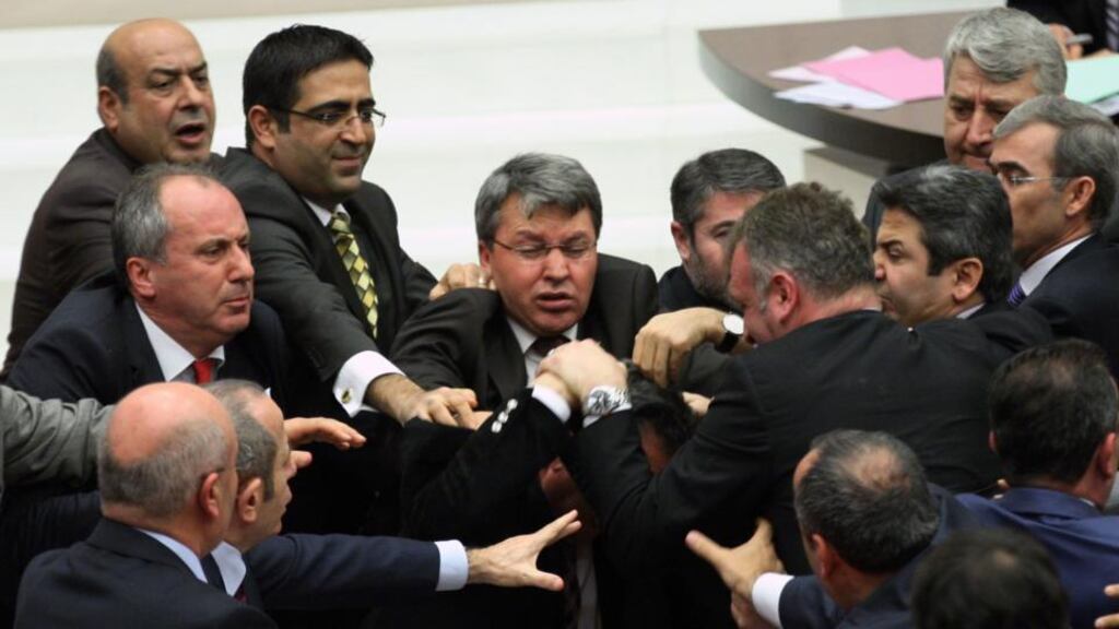 Ruling party politicians (right), and the members of the main opposition brawl in Turkey’s parliament during a debate over a corruption scandal that has ensnared prime minister Recep Tayyip Erdogan’s government. Photograph: AP