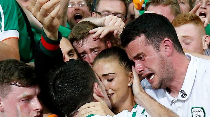 Robbie Brady celebrates with his long-term girlfriend Kerrie Harris AND his brother Gareth. Photo: Laurent Dubrule: EPA