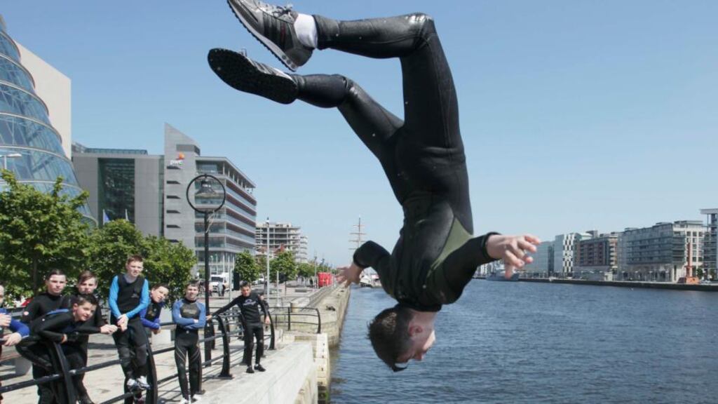 Dublin youths take advantage of the good weather in Dublin yesterday afternoon. Photograph: Stephen Collins/Collins Photos