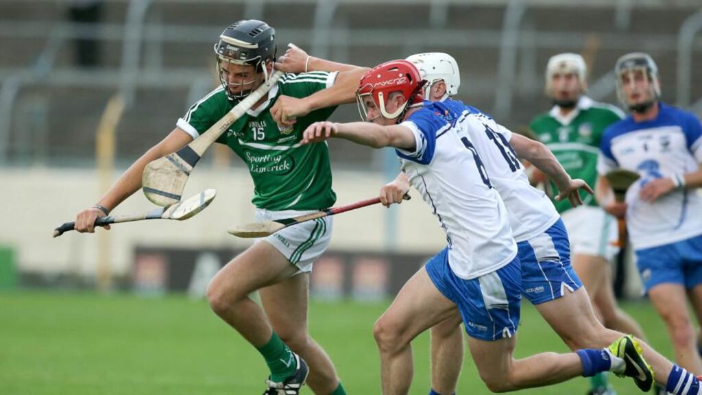 Limerick’s Colin Ryan (left) battles for possession with Jack Mullaney and Peter Hogan of Waterford during last night’s Munster MHC replay at Semple Stadium in Thurles. Photograph: Morgan Treacy/Inpho