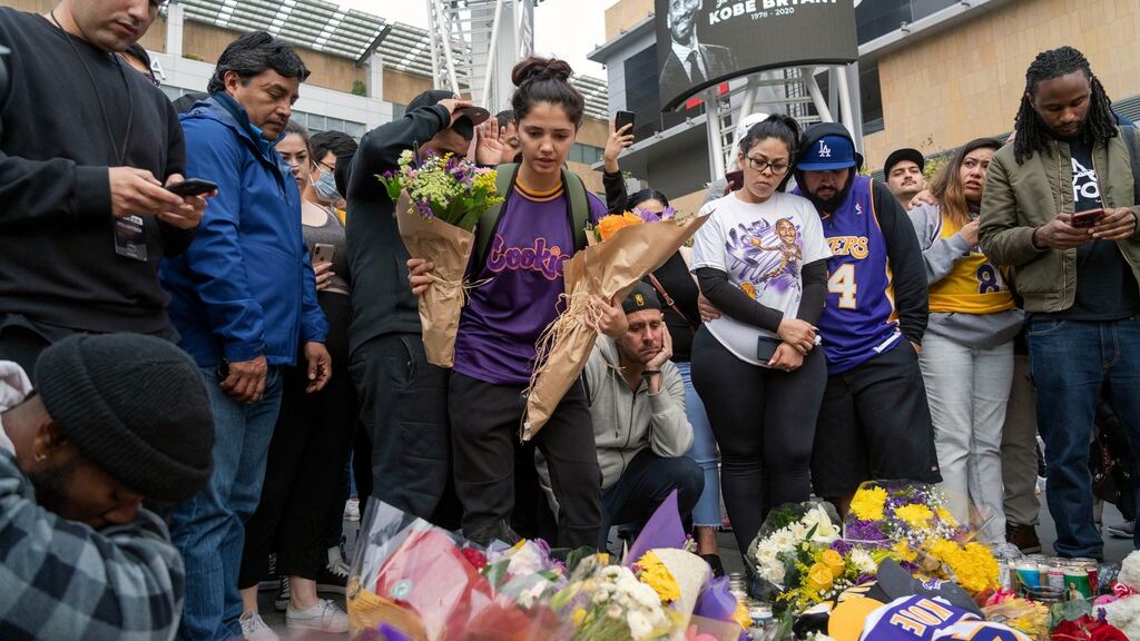 People gather at a vigil outside the Staples Center in Los Angeles on Monday to remember basketball player Kobe Bryant, who died in a helicopter crash on Sunday. Photograph: Philip Cheung/The New York Times.