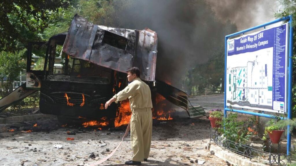 A firefighter stands near a burning bus after a bomb attack in Quetta, Pakistan. Photograph: Naseer Ahmed/Reuters
