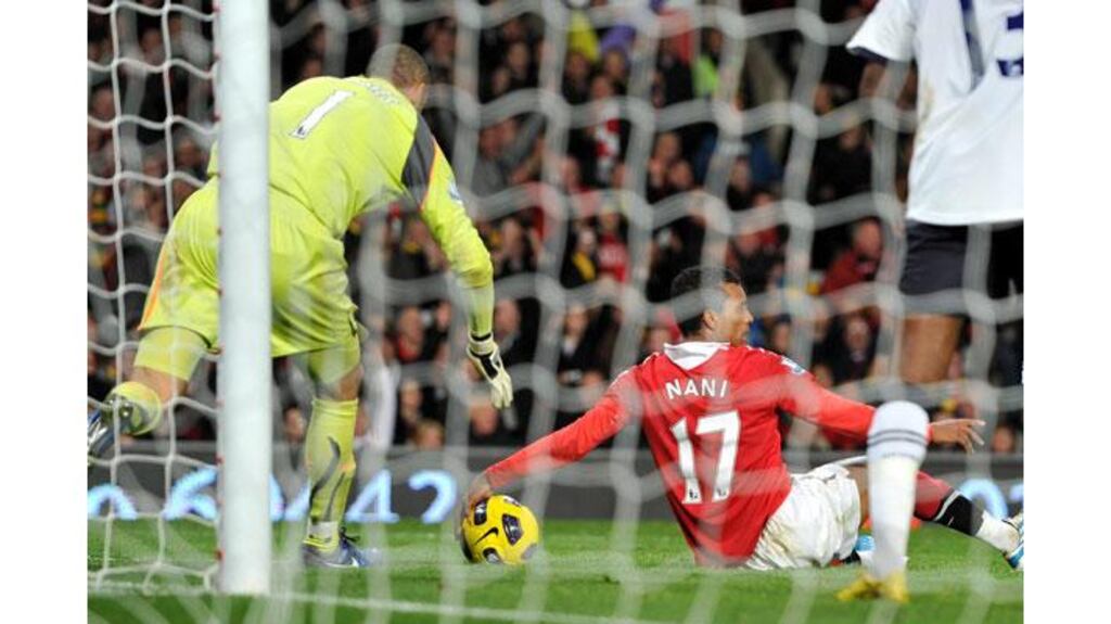 Manchester United's Luis Nani appears to handle the ball after falling in the penalty area and scored United's controversial second in their 2-0 win against Tottenham (Photograph: Martin Rickett/PA Wire)