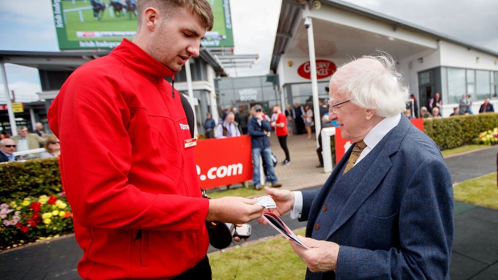 President Michael D Higgins places a bet with John Hamilton from the Tote during the 2017 Galway Festival. Photograph: James Crombie/Inpho