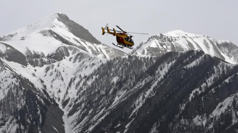 A rescue helicopter flies over the French Alps near the crash site at Seyne-les-Alpes. Photograph: Jean-Paul Pelissier/Reuters