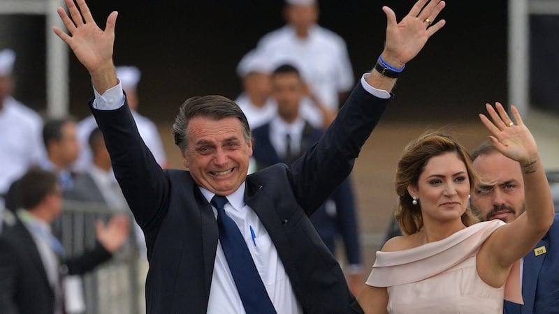 Brazil’s Jair Bolsonaro next to his wife Michelle Bolsonaro in Brasilia in January. Photograph: Carl de Souza/AFP via Getty Images
