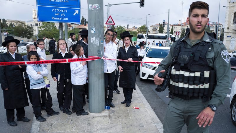 Ultra-Orthodox Jewish children stand behind a police line in East Jerusalem, near the Damascus Gate. Photograph: Jim Hollander/EPA