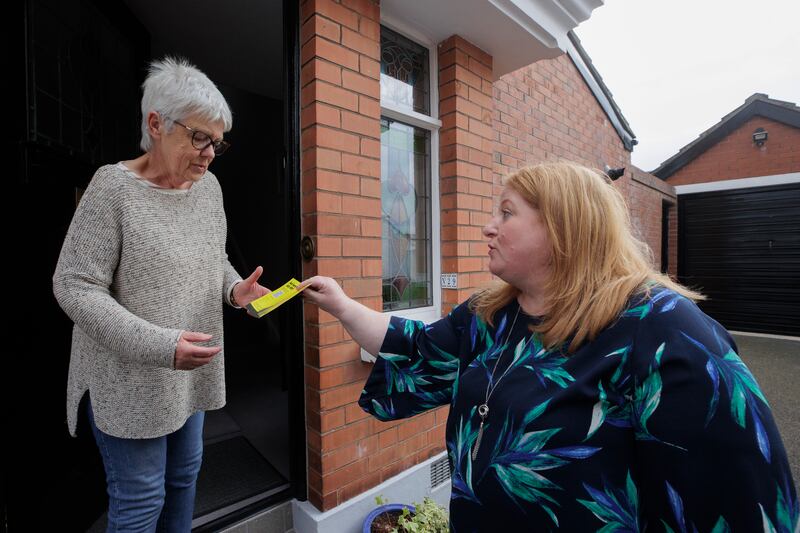 Alliance leader Naomi Long hands a flyer to Phyllis Younge while canvassing in East Belfast. Photograph: Liam McBurney/PA Wire
