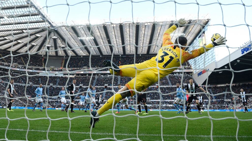 Manchester City goalkeeper Edderson dives in vain as a shot from Jonjo Shelvey sails into the net for the Newcastle equaliser. Photograph:  Stu Forster/Getty Images