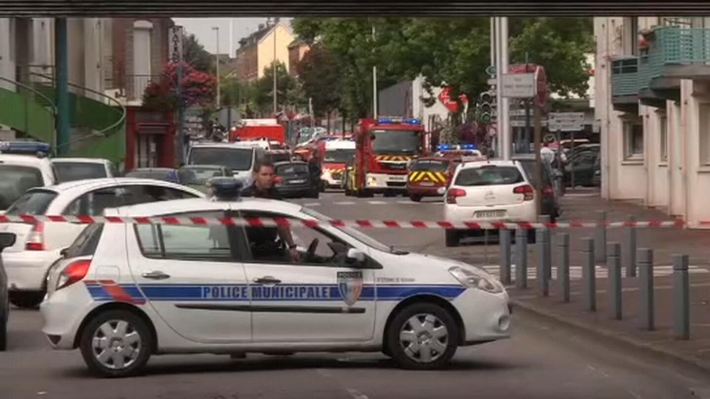 Police officers close off a road during a hostage situation in Normandy, France. Photograph: BFM via AP