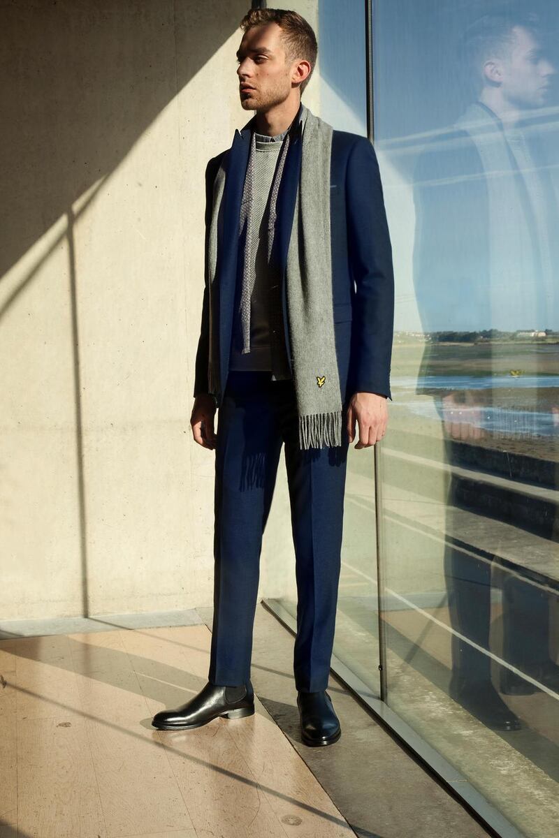 Navy blue suit Remus Uomo €349, lambswool scarf Lyle & Scott €45, paisley dress scarf €55 Gagliardi, charcoal shirt €85 Armani Exchange, grey textured sweat shirt €155 Samsoe & Samsoe, black leather Chelsea boots Kurt Geiger €225.