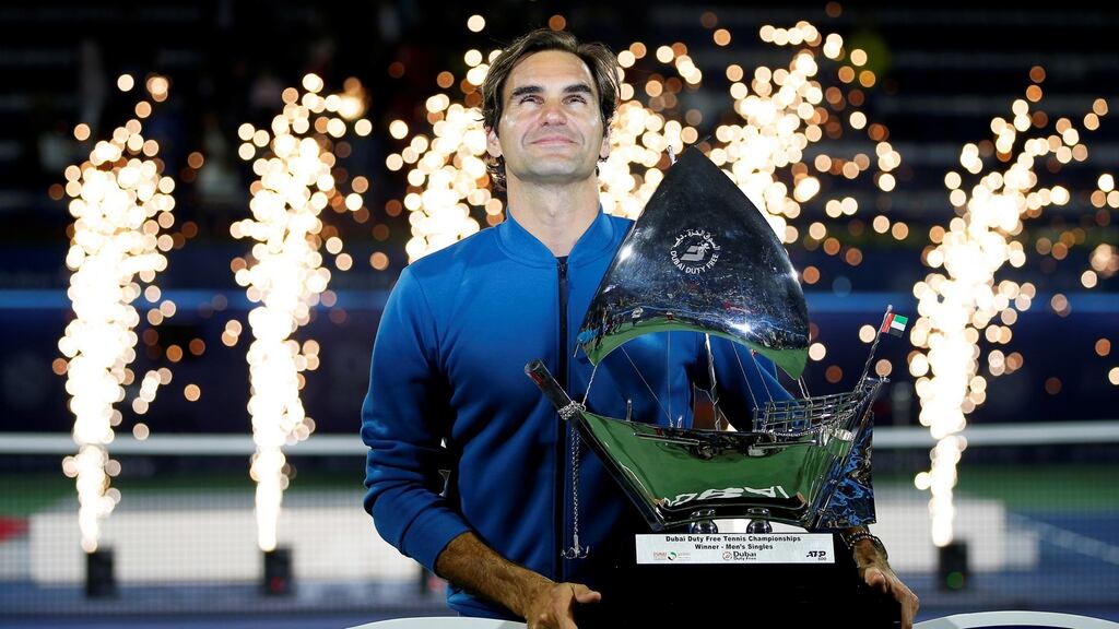 Roger Federer poses with his trophy after defeating Stefanos Tsitsipas of Greece in their final match in Dubai to claim his 100th title win. Photograph: Ali Haider/EPA