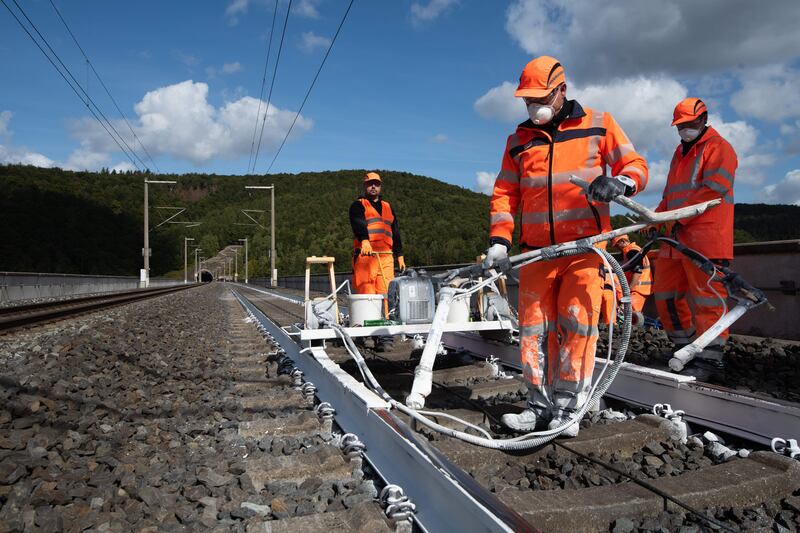 German rail workers paint rails white in an effort to reflect heat from the surface and prevent damage. Photograph: Swen Pfortner/DPA/AFP via Gettty