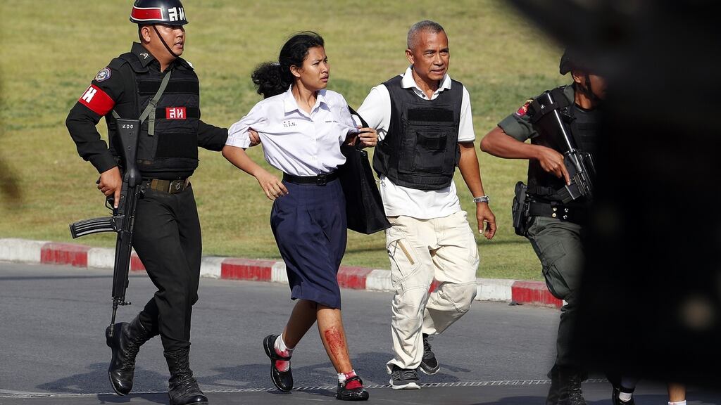 Soldiers evacuate a woman from the scene of a mass shooting  at the Terminal 21 shopping mall in Nakhon Ratchasima, Thailand. Photograph: EPA/RungroJ Yongrit