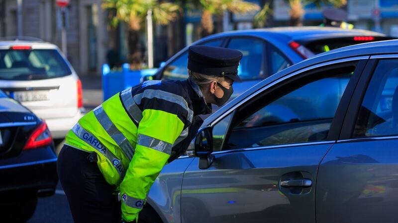 A garda speaks to a car’s occupants at a checkpoint on O’Connell Bridge in Dublin as Level 5 restrictions against Covid-19 continue to be enforced, on Monday, November 2nd. Photograph: Collins