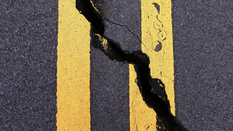 A crack cuts through the roadway caused by seismic activity from the Kilauea volcano on Hawaii’s Big Island, on Thursday. Photograph: Mario Tama/Getty Images