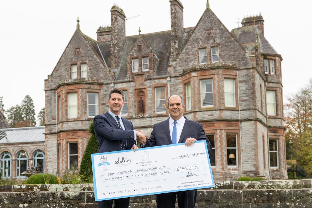 Sam Shephard, gold award winner at the inaugural North-South Business Cooperation Awards, receiving his €150,000 cheque from the awards founder, Stelios Haji-Ioannou. Photograph: Naoise Culhane
