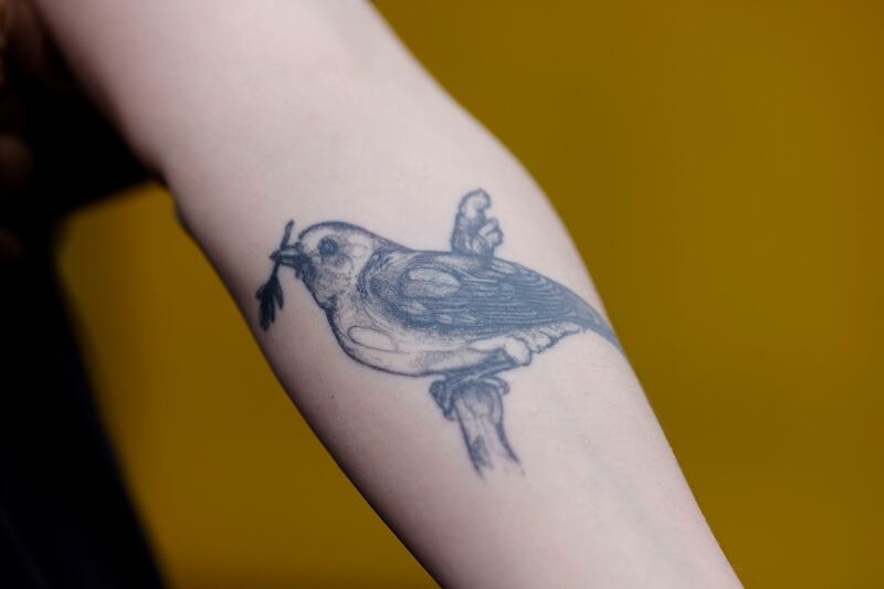 Kerri Ní Dochartaigh’s tattoo of a canary. Photograph: Alan Betson