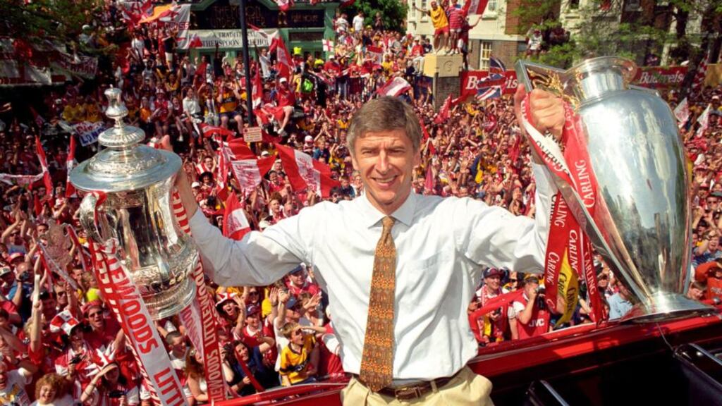 Arsenal manager Arsene Wenger posing with the FA and League Cups the club won in 1998. Photo: John Stillwell/PA
