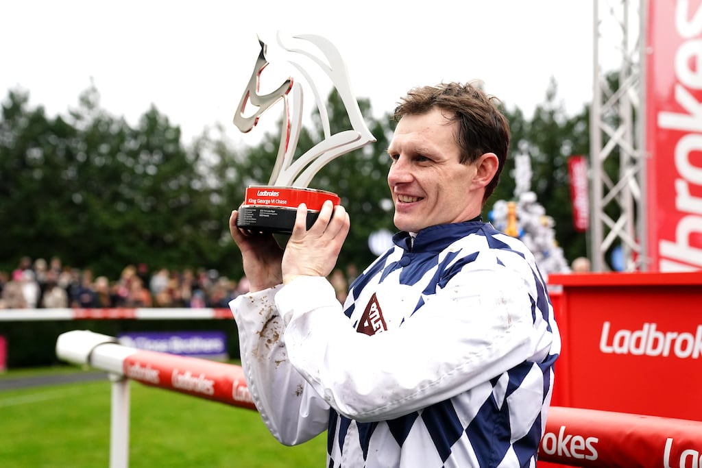 Jockey Paul Townend celebrates with the trophy after winning the Ladbrokes King George VI Chase with Banbridge. Photograph: John Walton/PA