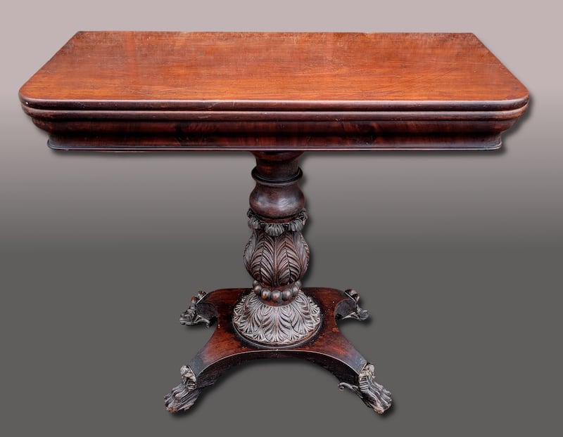 A 19th century mahogany fold over table with superb carved detail at the base, €800-€1,200 (Hegarty's).