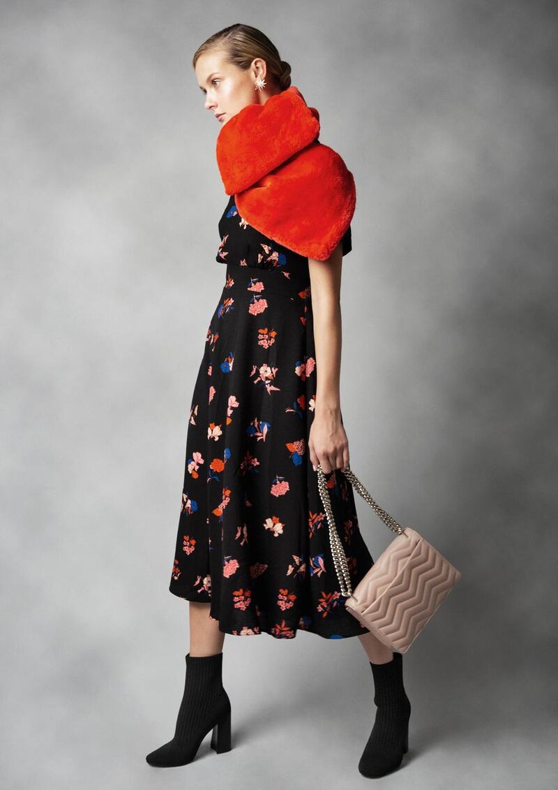 Black floral dress Essentiel Antwerp €249, red faux fur stole, Essentiel Antwerp €119, salmon leather bag Kate Spade, nova stud star earrings Lulu Frost at Loulerie €199, black sock boots Kendall & Kylie €225