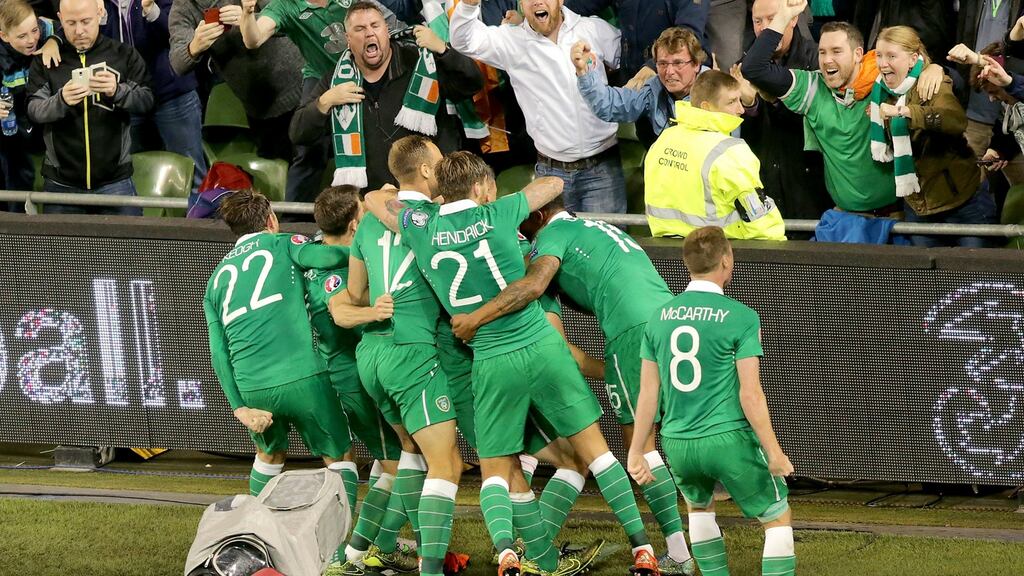 Republic of Ireland  players congratulate goalscorer Shane Long after their victory over Germany: Photograph: INPHO/Morgan Treacy