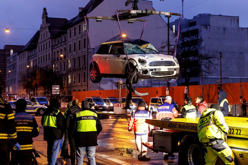 A car is lifted on to a lorry at the scene of the attack. Photograph: Matthias Balk/dpa/AP