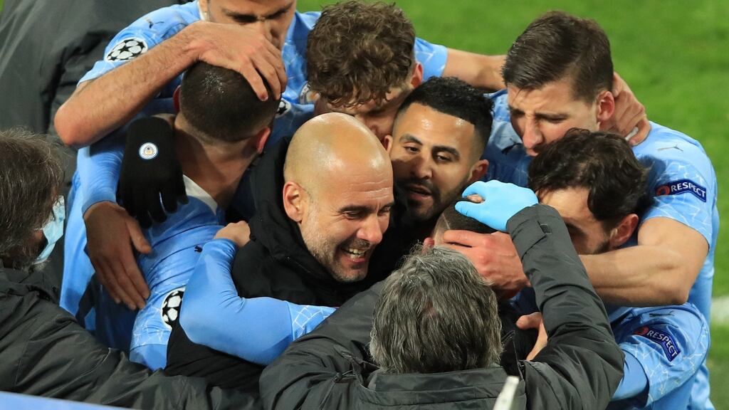 Phil Foden celebrates scoring the second goal with his team-mates and Manchester City manager Pep Guardiola during the Champions League quarter-final, second leg against Borussia Dortmund. Photograph: Wolfgang Rattay/AFP via Getty Images