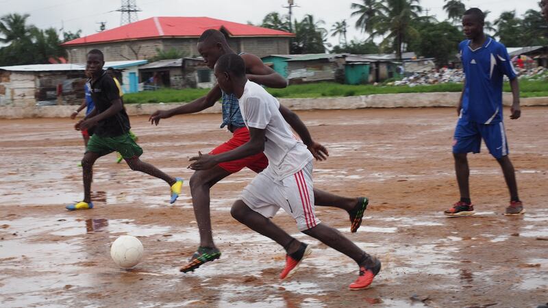 Local youths playing football on the pitch where George Weah started playing with a rag ball in Clara Town, Monrovia. Photograph: Lorraine Mallinder