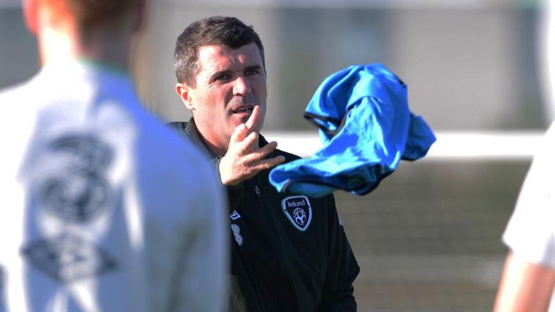 New Republic of Ireland assistant manager Roy Keane tosses out a training bib as he organises his first squad training session at Malhide yesterday. Photograph: Cyril Byrne/The Irish Times