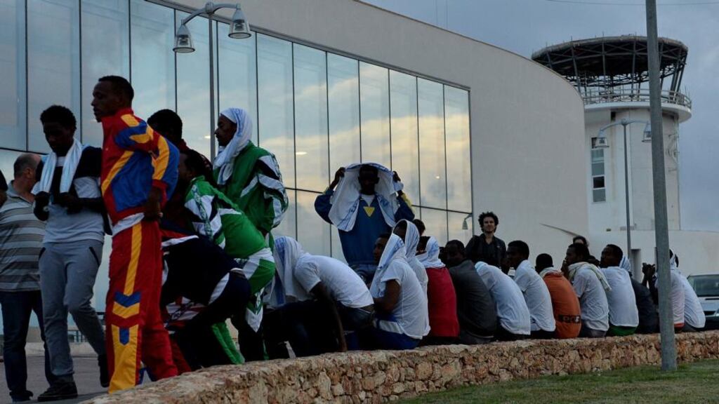 Immigrants attend a ceremony for some of the African migrants killed in a shipwreck off the Italian coast at the Lampedusa airport. Photograph: Tullio M. Puglia/Getty Images.