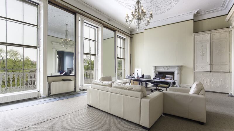 At first floor level, the grandest rooms in the house have windows that stand at least 12 feet tall