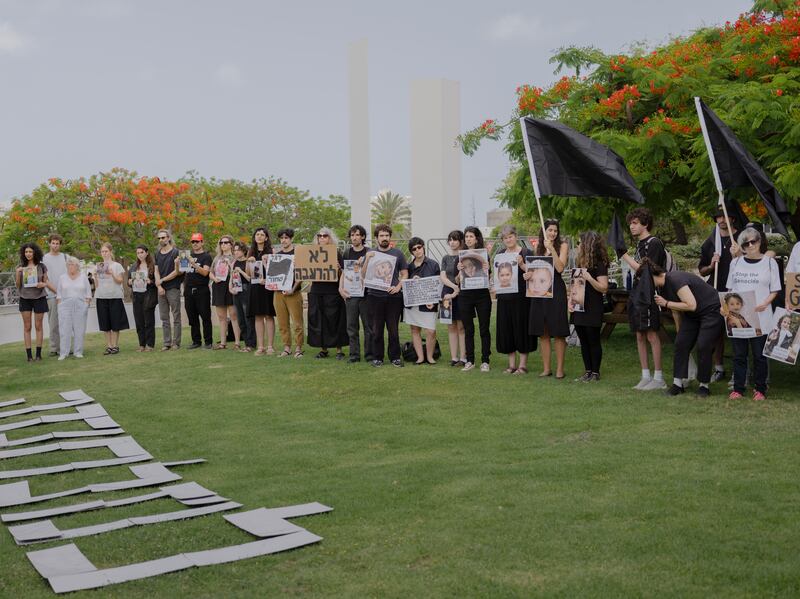 Students at Tel Aviv University hold images of Israeli hostages held by Hamas and children killed in Israeli airstrikes in Gaza, in May. Photograph: Amit Elkayam/New York Times