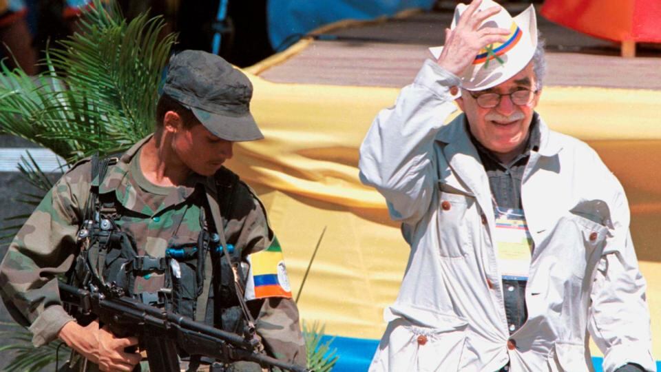 1999: Garcia Marquez walks alongside a leftist rebel during the opening of the peace talks in San Vicente del Caguan