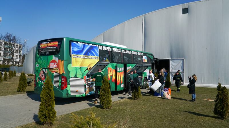 A Paddywagon tour bus arrives in Piaseczno, a suburb of Warsaw, with five busloads of aid for the community on Friday. Photograph: Enda O’Dowd