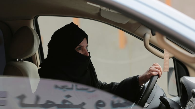 In this 2014 photograph Aziza Yousef drives a car in Riyadh as part of a campaign to defy Saudi Arabia’s ban on women driving. Photograph: AP Photo/Hasan Jamali