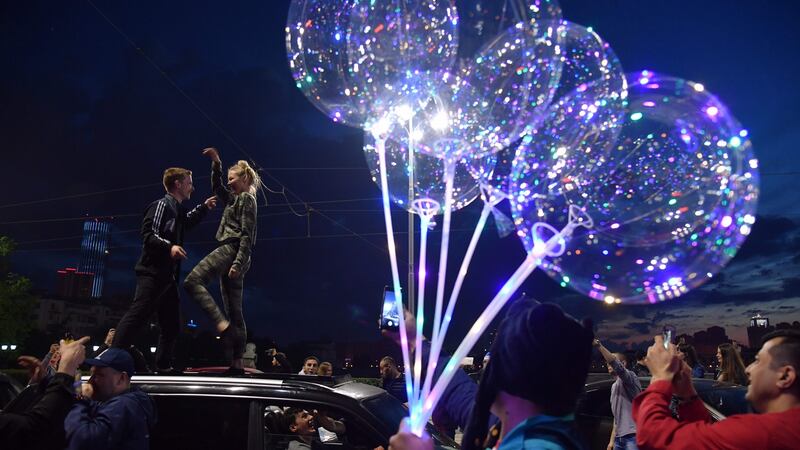 Russian fans dance on a car as they celebrate in the streets of Ekaterinburg after their team’s victory over Egypt. Photograph: Hecto Retamal/AFP/Getty