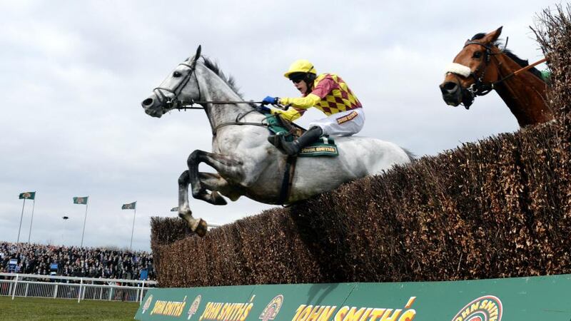 Dynaste and Tom Scudamore (left) jump the final fence on their way to victory in the John Smiths Mildmay Novices Chase at Aintree. Photograph: John Giles/PA Wire