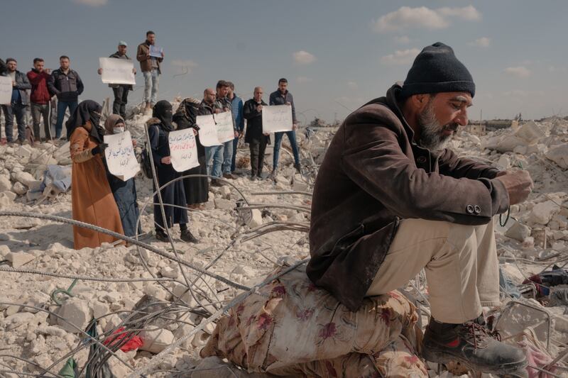 People protest the lack of aid amidst rubble from the earthquake in the government-held city of Atarib, Syria, on February 12th. Photograph: Emily Garthwait/New York Times