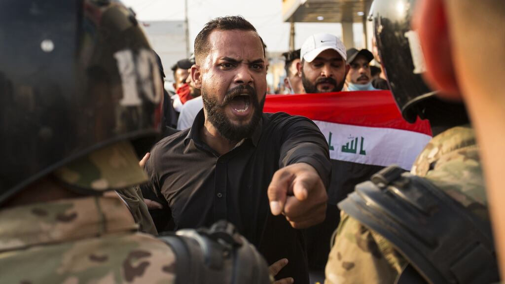 An Iraqi protestor gestures in front of security forces during a demonstration against state corruption, failing public services and unemployment, on Wednesday in the southern city of Basra. Photograph: Getty Images