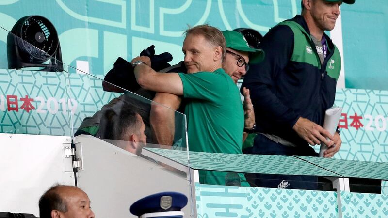 Joe Schmidt hugs scrum coach Greg Feek after the defeat to New Zealand in Tokyo. Photograph: Dan Sheridan/Inpho