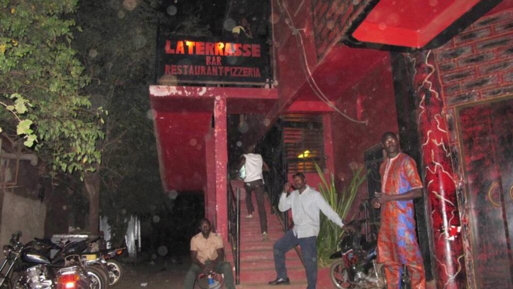 Locals stand outside La Terrasse bar in the Hippodrome neighbourhood of Bamako, Mali, where militants killed five people, including a French citizen and a Belgian citizen, in a gun attack on Saturday. Photograph: Alex Duval Smith/EPA