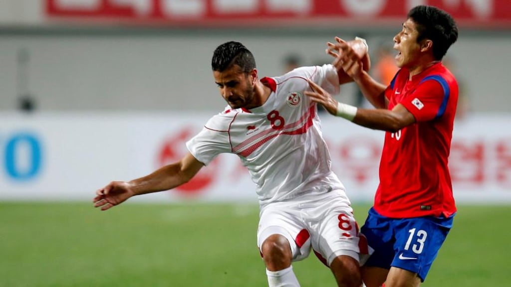 Tunisian Khaled Korbi (left) fights for the ball with South Korea’s Lee Keunho (right)  at Sangam World Cup Stadium in Seoul, South Korea. Photograph: Jeon Heon-Kyun / EPA