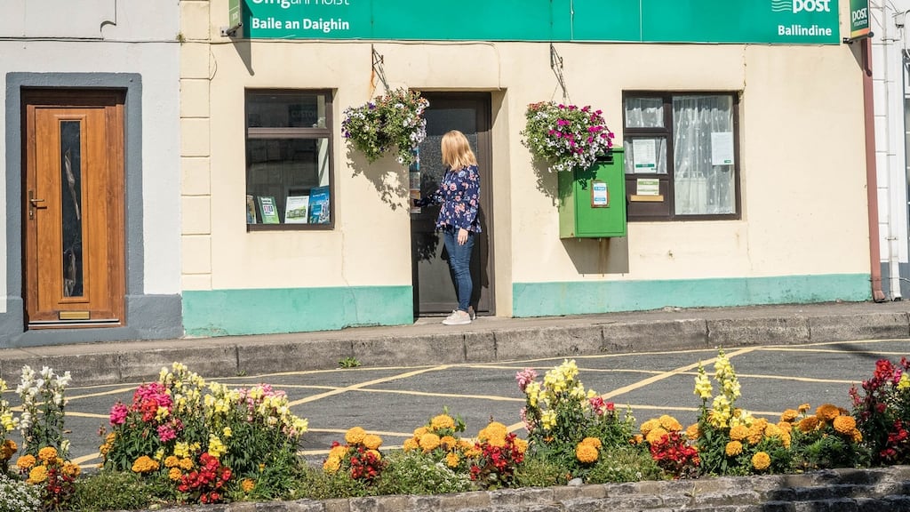Ann Gilmore closes the door for on the last day of business at the Post Office in Ballindine, Co Mayo. Photograph: Keith Heneghan