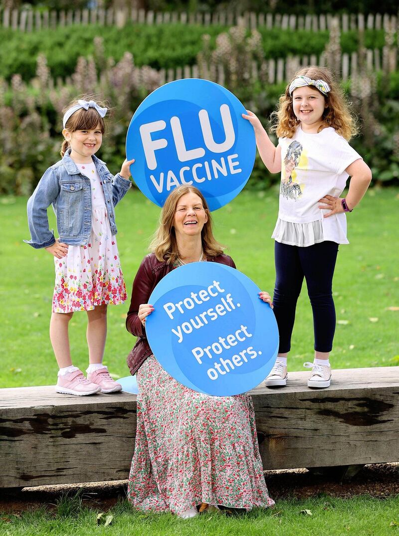 Megan Ayres (9) and Evelyn Ayres (6) from Co Meath, got their flu vaccines to protect themselves and their grandma, Geraldine Murtagh. Photograph: Marc O’Sullivan