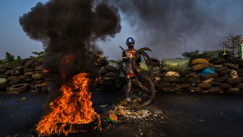 Protesters burn tyres on a bridge in an attempt to block security forces from passing through a major traffic hub in Yangon on Wednesday. Photograph: The New York Times