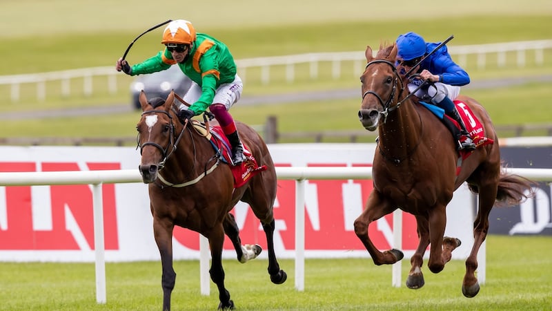 William Buick and Hurricane Lane (blue) chase down Frankie Dettori onboard Lone Eagle to win the Dubai Duty Free Irish Derby at the Curragh on Saturday. Photograph: Morgan Treacy/Inpho