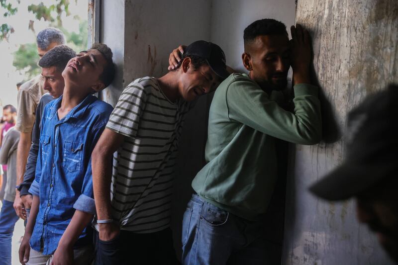 Palestinians mourn outside Al-Shifa hospital morgue in Gaza City where bodies of people killed a day earlier while waiting for aid were brought, at the Al-Shifa hospital morgue in Gaza City on Thursday. Photograph: Bashar Taleb/AFP via Getty Images